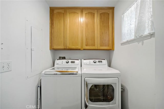 washroom with cabinet space and separate washer and dryer