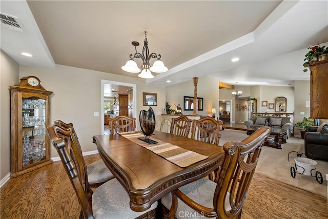 dining area with a chandelier, recessed lighting, baseboards, and light wood-type flooring