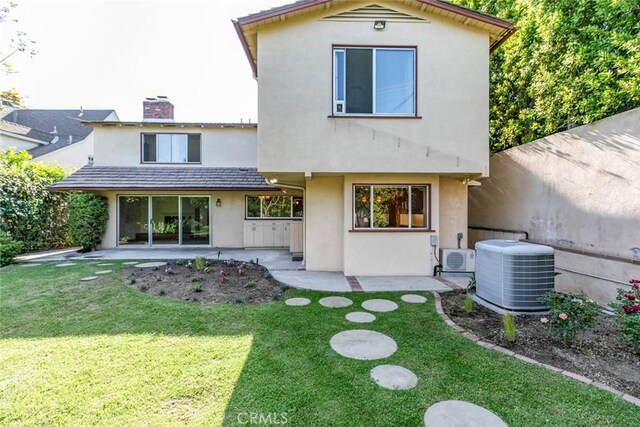 1558 Hillcrest Ave, Glendale, CA 91202 - back of property featuring central AC, a patio area, stucco siding, a chimney, and a lawn