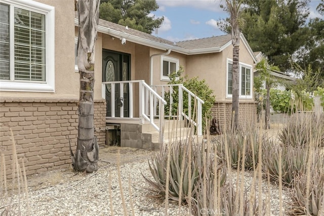 7857 Whitsett Ave, North Hollywood, CA 91605 - entrance to property with stucco siding, brick siding, and a shingled roof