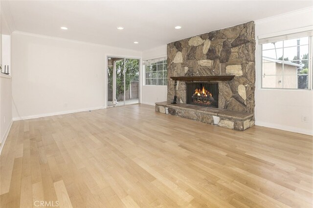 7857 Whitsett Ave, North Hollywood, CA 91605 - unfurnished living room with ornamental molding, a stone fireplace, wood finished floors, baseboards, and recessed lighting