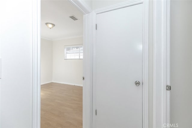 7857 Whitsett Ave, North Hollywood, CA 91605 - hallway featuring light wood-style floors, baseboards, and crown molding