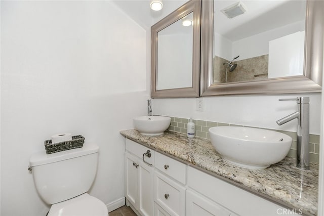 7857 Whitsett Ave, North Hollywood, CA 91605 - bathroom featuring backsplash, double vanity, toilet, and a shower