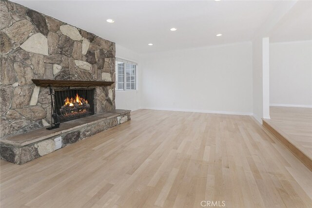 7857 Whitsett Ave, North Hollywood, CA 91605 - unfurnished living room with a stone fireplace, wood finished floors, crown molding, baseboards, and recessed lighting