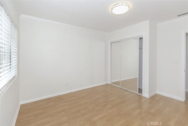 7857 Whitsett Ave, North Hollywood, CA 91605 - unfurnished bedroom featuring light wood-style floors, a closet, crown molding, and baseboards