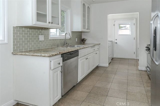 7857 Whitsett Ave, North Hollywood, CA 91605 - kitchen featuring stainless steel dishwasher, a sink, baseboards, tasteful backsplash, and white cabinetry