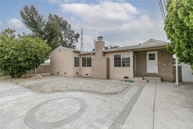7857 Whitsett Ave, North Hollywood, CA 91605 - view of front of property with stucco siding, a chimney, and a patio area