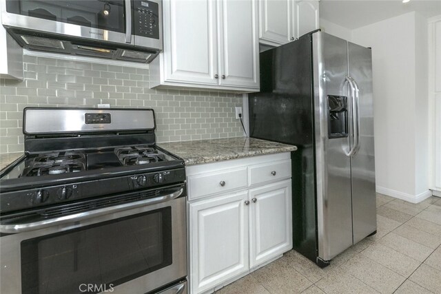 7857 Whitsett Ave, North Hollywood, CA 91605 - kitchen featuring stainless steel appliances, white cabinetry, baseboards, and decorative backsplash