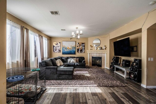 3035 Cat Tail Ct, Hemet, CA 92545 - living area with a chandelier, wood finished floors, and a tiled fireplace