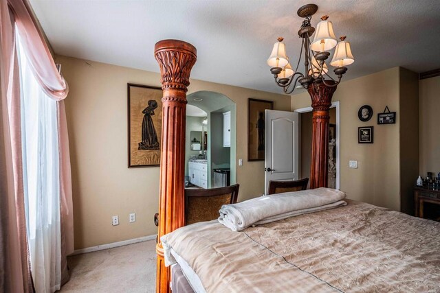 3035 Cat Tail Ct, Hemet, CA 92545 - bedroom with light colored carpet, arched walkways, and a chandelier