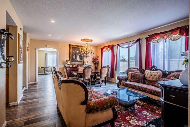 3035 Cat Tail Ct, Hemet, CA 92545 - living room featuring dark wood-type flooring, arched walkways, a chandelier, a textured ceiling, and recessed lighting
