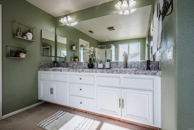 3035 Cat Tail Ct, Hemet, CA 92545 - bathroom featuring double vanity, a shower stall, and a textured wall