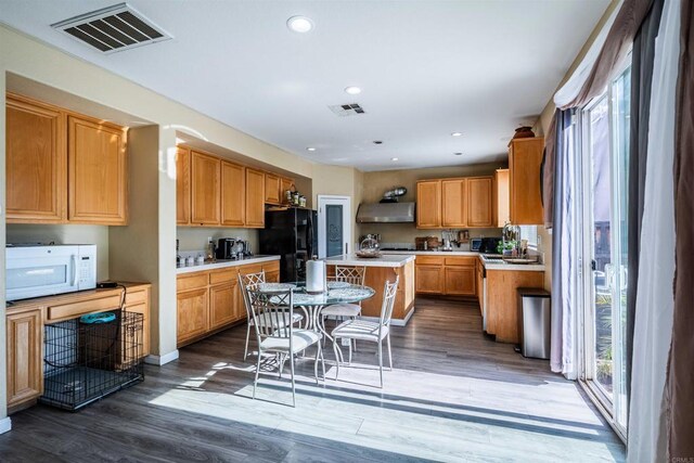 3035 Cat Tail Ct, Hemet, CA 92545 - kitchen featuring white microwave, freestanding refrigerator, exhaust hood, wood finished floors, and recessed lighting