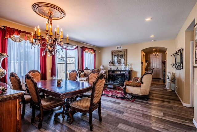 3035 Cat Tail Ct, Hemet, CA 92545 - dining room featuring a chandelier, arched walkways, wood finished floors, recessed lighting, and a textured ceiling