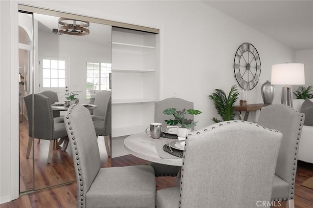 dining area with lofted ceiling and wood finished floors