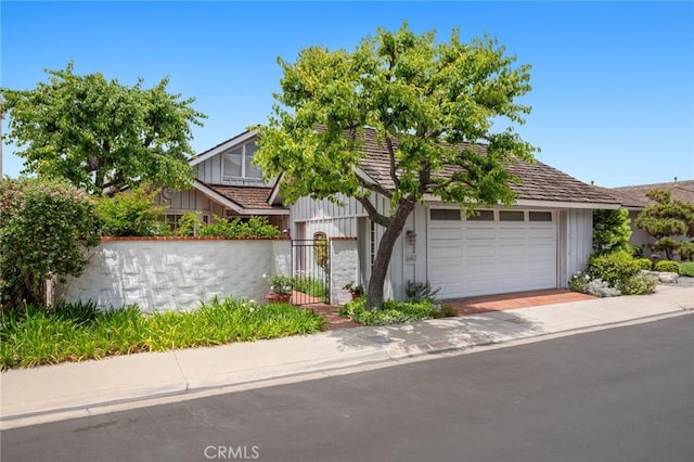 2005 Yacht Resolute, Newport Beach, CA 92660 - view of front of property featuring board and batten siding, an attached garage, and a gate