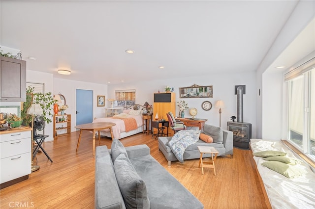 5664-5668 Clouds, Mariposa, CA 95338 - bedroom featuring a wood stove and light wood-style flooring
