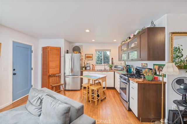 5664-5668 Clouds, Mariposa, CA 95338 - kitchen with appliances with stainless steel finishes, a sink, light wood-type flooring, glass insert cabinets, and light countertops