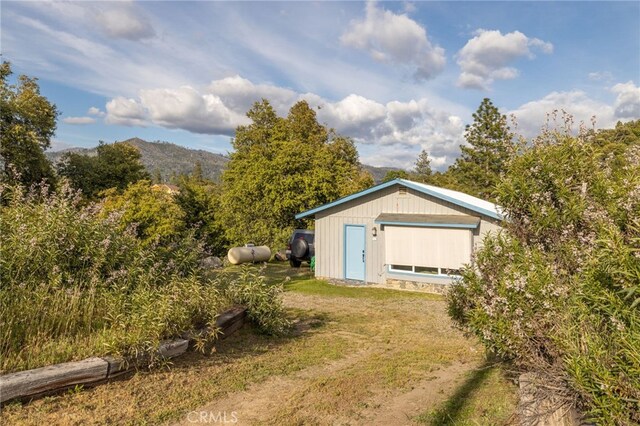 5664-5668 Clouds, Mariposa, CA 95338 - view of front facade featuring a mountain view and an outdoor structure