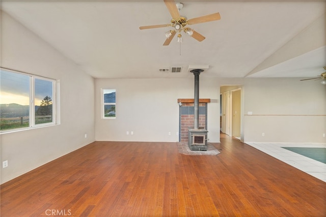5664-5668 Clouds, Mariposa, CA 95338 - unfurnished living room with a ceiling fan, a wood stove, lofted ceiling, and wood finished floors