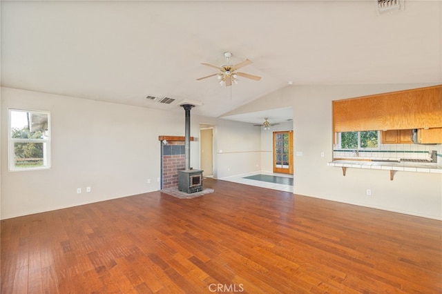 5664-5668 Clouds, Mariposa, CA 95338 - unfurnished living room with ceiling fan, a wood stove, wood finished floors, and lofted ceiling