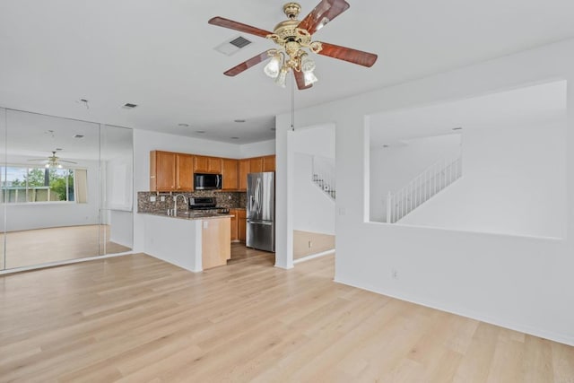 8580 New Salem St Unit 7, San Diego, CA 92126 - kitchen with appliances with stainless steel finishes, a ceiling fan, open floor plan, a peninsula, and tasteful backsplash