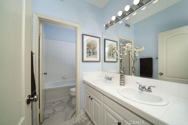 26 Upland, Irvine, CA 92602 - full bathroom with marble finish floors, double vanity, toilet, and washtub / shower combination