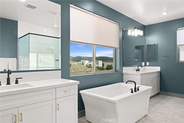 920 Bunkhouse Dr, Rancho Mission Viejo, CA 92694 - bathroom featuring a freestanding tub, two vanities, and a shower