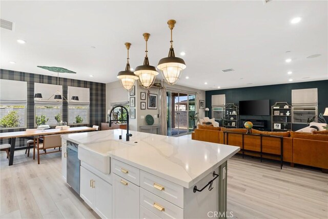 920 Bunkhouse Dr, Rancho Mission Viejo, CA 92694 - kitchen featuring white cabinetry, light wood-type flooring, dishwasher, light stone countertops, and recessed lighting