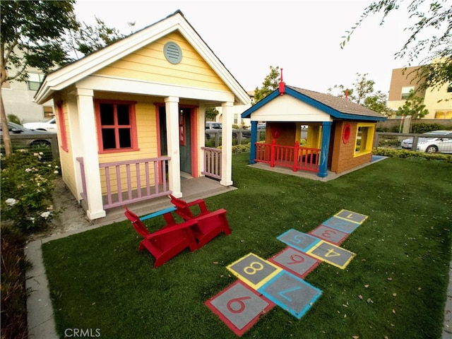 920 Bunkhouse Dr, Rancho Mission Viejo, CA 92694 - back of house with an outdoor structure and a lawn
