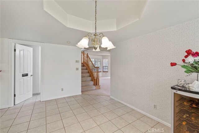 50711 Rd 426, Oakhurst, CA 93644 - unfurnished room featuring baseboards, a raised ceiling, a chandelier, wallpapered walls, and stairway