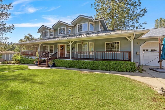 50711 Rd 426, Oakhurst, CA 93644 - view of front of house with a garage, covered porch, a front lawn, and a standing seam roof