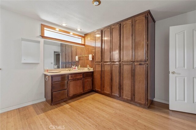 50711 Rd 426, Oakhurst, CA 93644 - full bath featuring double vanity, wood finished floors, and baseboards