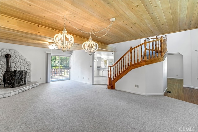 50711 Rd 426, Oakhurst, CA 93644 - unfurnished living room with a chandelier, wooden ceiling, stairway, carpet, and a wood stove
