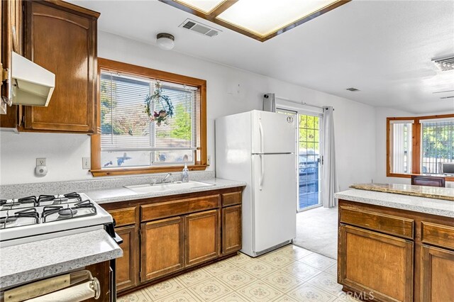 50711 Rd 426, Oakhurst, CA 93644 - kitchen featuring white appliances, light countertops, brown cabinets, and ventilation hood