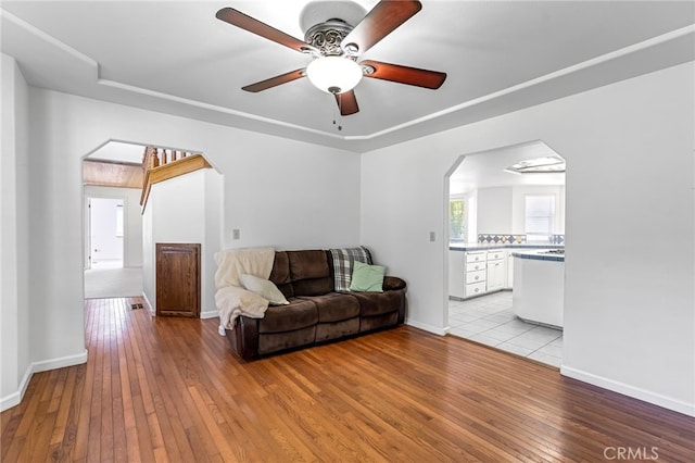 50711 Rd 426, Oakhurst, CA 93644 - living area with arched walkways, light wood finished floors, and a ceiling fan