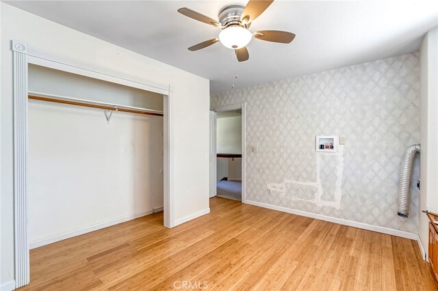 50711 Rd 426, Oakhurst, CA 93644 - unfurnished bedroom with light wood-style floors, a closet, wallpapered walls, and ceiling fan