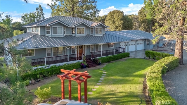 50711 Rd 426, Oakhurst, CA 93644 - view of front of property featuring a metal roof, a garage, covered porch, a front yard, and concrete driveway