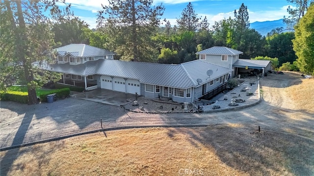 50711 Rd 426, Oakhurst, CA 93644 - view of front of house featuring a garage, driveway, and a metal roof