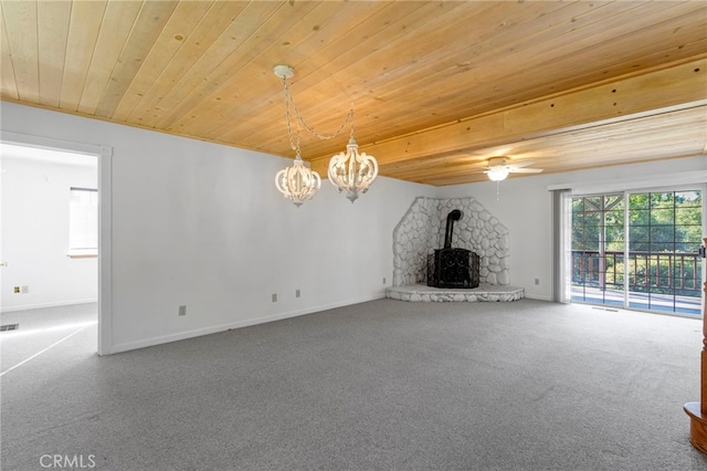 50711 Rd 426, Oakhurst, CA 93644 - unfurnished living room featuring wooden ceiling, a wood stove, a chandelier, and carpet flooring
