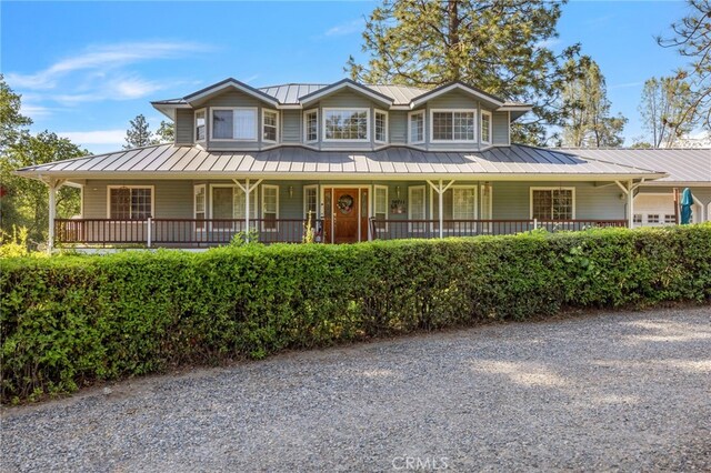 50711 Rd 426, Oakhurst, CA 93644 - farmhouse inspired home featuring a metal roof, a porch, and a standing seam roof