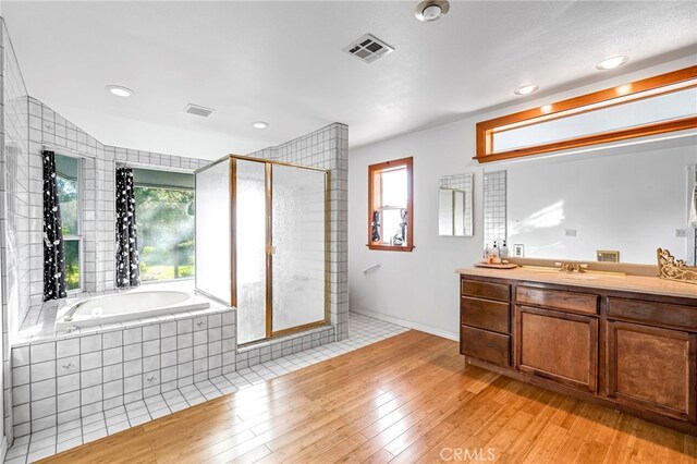 50711 Rd 426, Oakhurst, CA 93644 - full bath with plenty of natural light, vanity, a garden tub, a stall shower, and recessed lighting