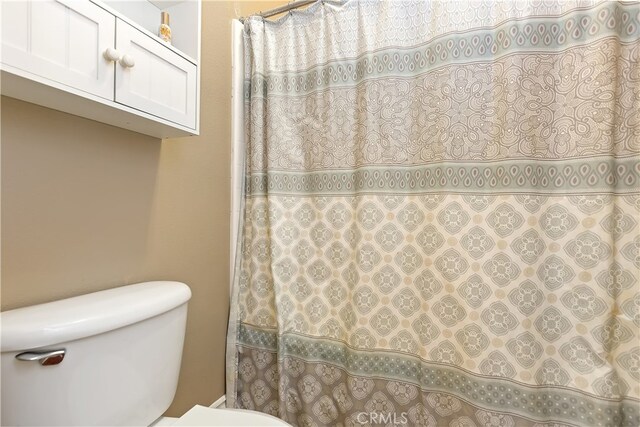 28759 Eridanus Dr, Menifee, CA 92586 - bathroom featuring toilet and a shower with curtain