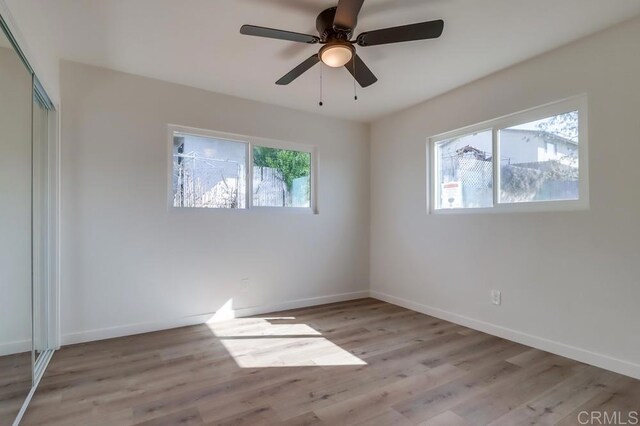 1215 Grand Ave, Spring Valley, CA 91977 - unfurnished bedroom featuring baseboards, wood finished floors, a closet, and a ceiling fan