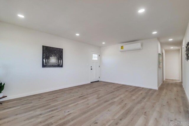 1215 Grand Ave, Spring Valley, CA 91977 - foyer entrance featuring a wall mounted AC, light wood-style flooring, recessed lighting, and baseboards