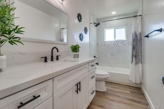 1215 Grand Ave, Spring Valley, CA 91977 - full bathroom with vanity, toilet, shower / bathtub combination with curtain, and wood finished floors