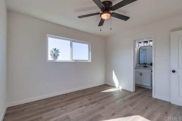 1215 Grand Ave, Spring Valley, CA 91977 - unfurnished bedroom featuring light wood-type flooring, baseboards, ensuite bathroom, and a sink