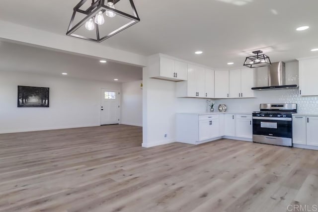 1215 Grand Ave, Spring Valley, CA 91977 - kitchen featuring stainless steel gas stove, wall chimney range hood, a chandelier, light wood-style floors, and recessed lighting