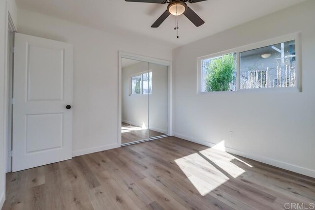 1215 Grand Ave, Spring Valley, CA 91977 - unfurnished bedroom featuring a closet, wood finished floors, baseboards, and ceiling fan