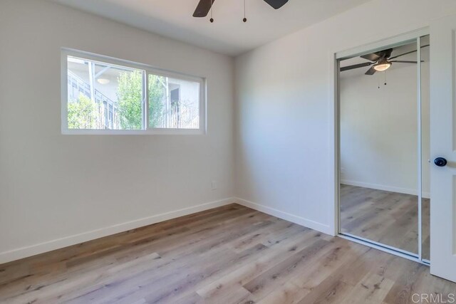 1215 Grand Ave, Spring Valley, CA 91977 - unfurnished bedroom featuring wood finished floors, baseboards, a closet, and ceiling fan